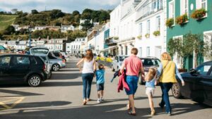 family walking in gorey jersey hand in hand past shops