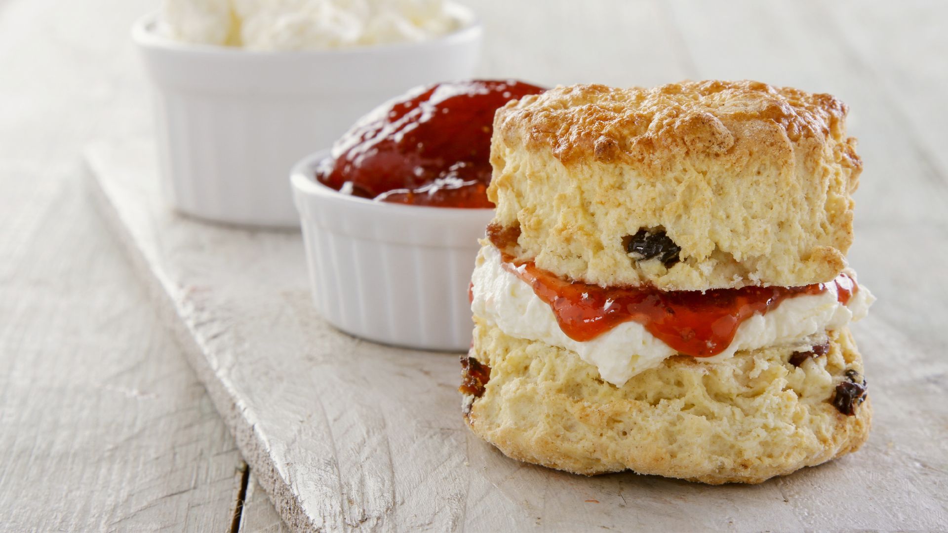 scone cream and jam on a wooden board