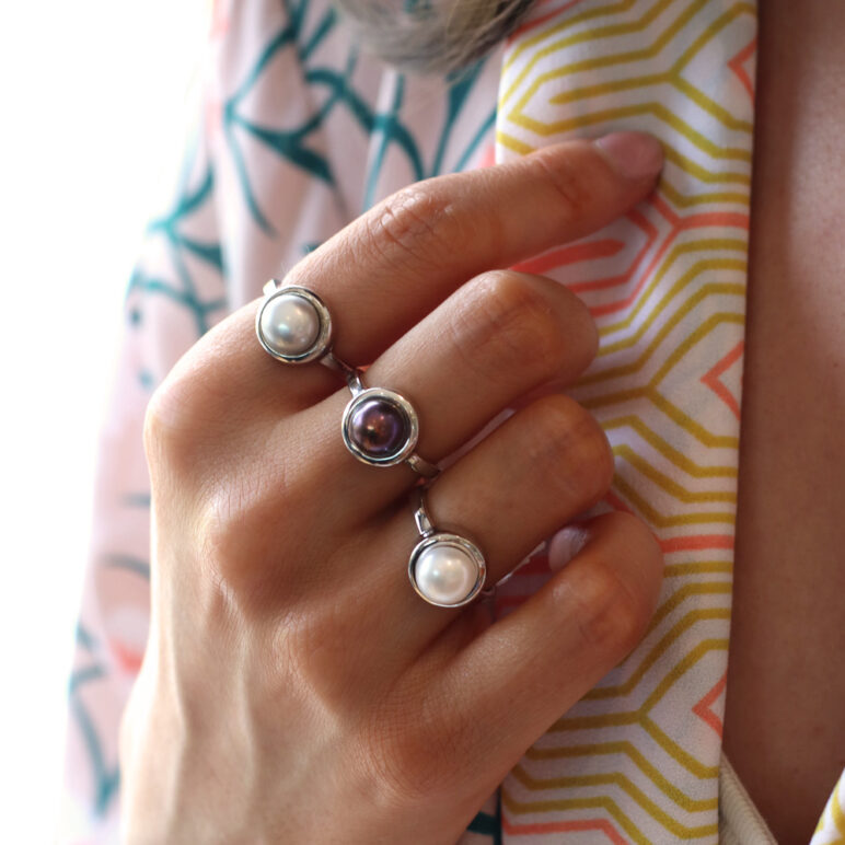 Model wearing Alice Freshwater pearl sterling silver ring - white, peacock and grey