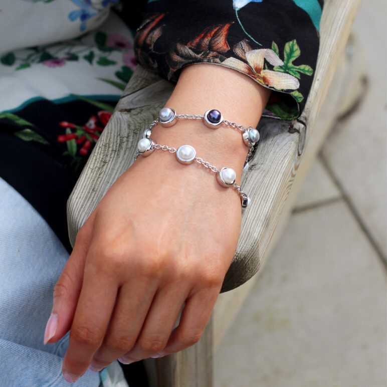 Model wearing Alice White Bracelet, paired with Alice Multi-Freshwater Pearl Bracelet