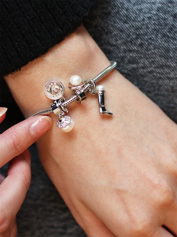 models wrist with jersey pearl charms on a bracelet