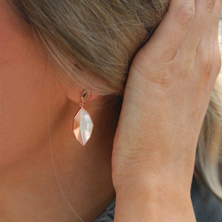 Model wearing rose gold plated Kyra drop earrings