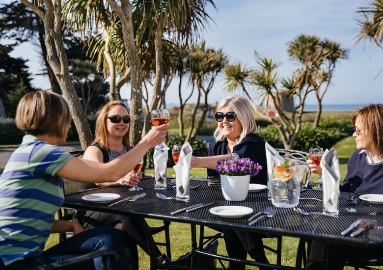 ladies raising a glass in the pearl cafe sun terrace