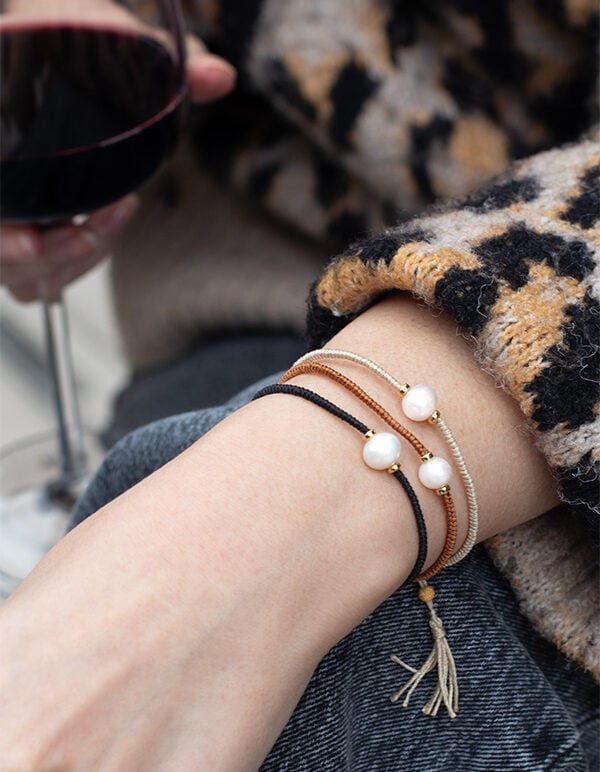 Model wearing Jersey Pearl Tassel Bracelets, Black, Tan and Daiquiri