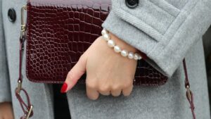 model holding handbag wearing zara pearl bracelet