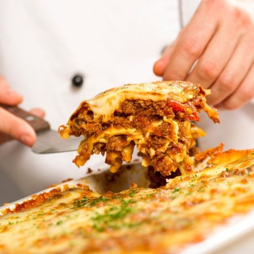 chef plating up homemade lasagne at jersey pearl cafe