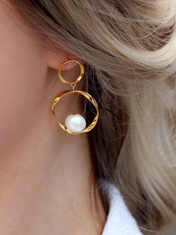 model with baroque hoop earrings in