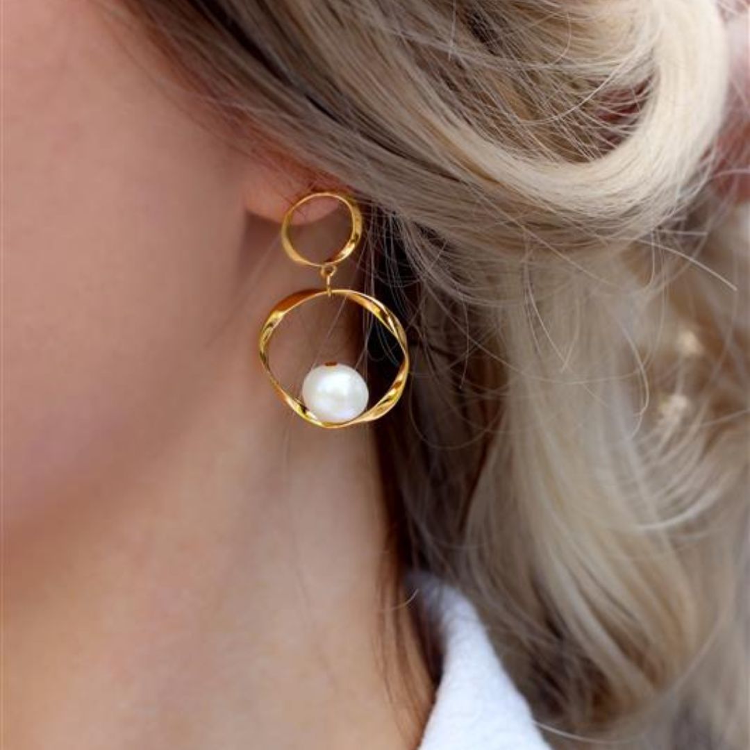 model with baroque hoop earrings in