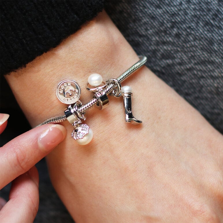 models wrist with jersey pearl charms on a bracelet